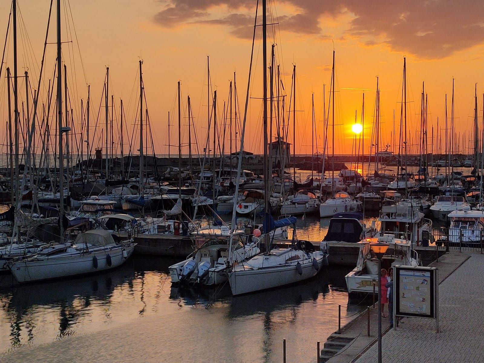 The pontoons at sunset, harbour entrance beyond