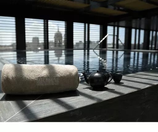 The pool edge, towards the rooftops
