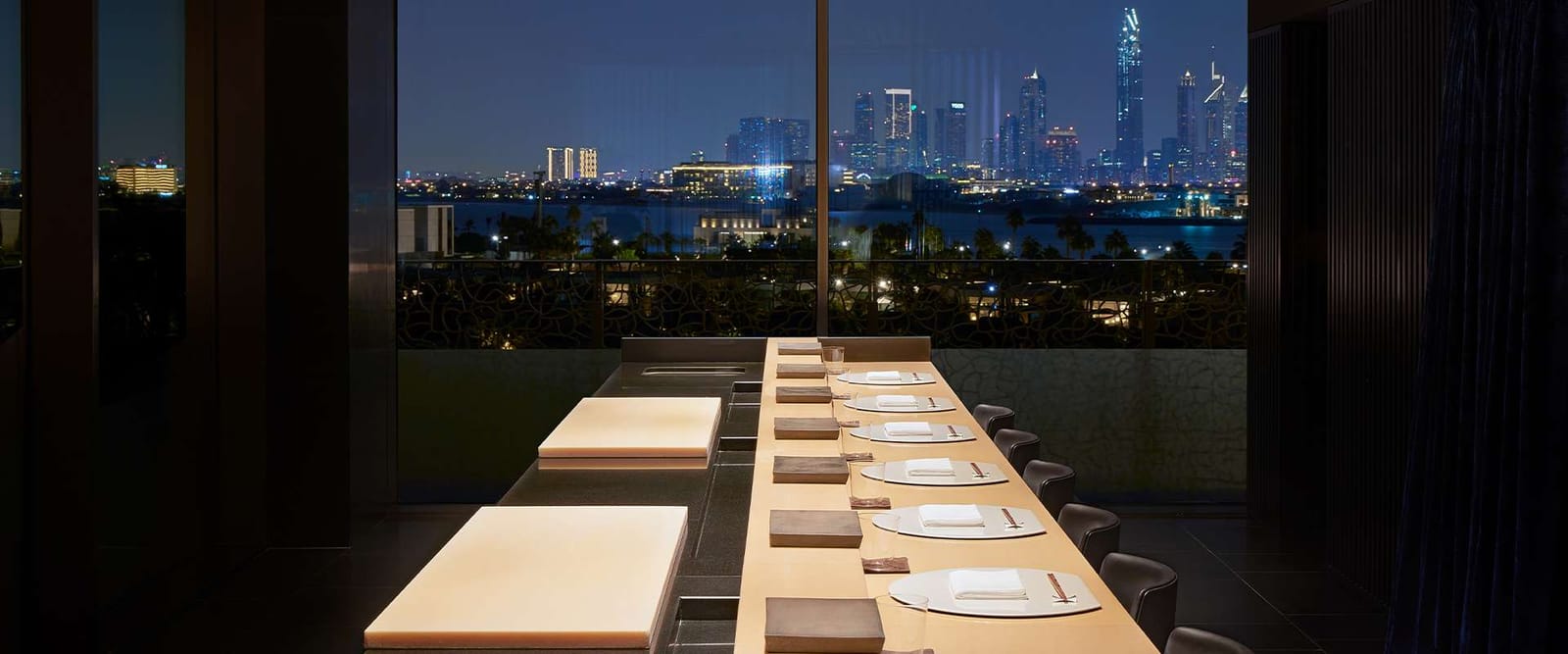 A counter laid for dinner, facing the skyline