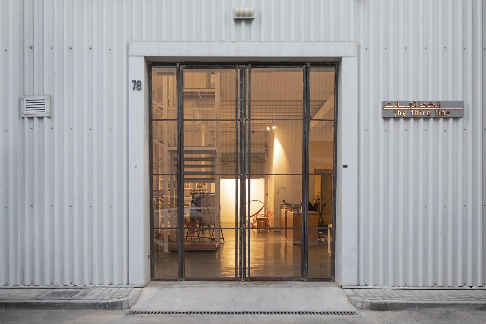The glass doors of Warehouse 78 at dusk