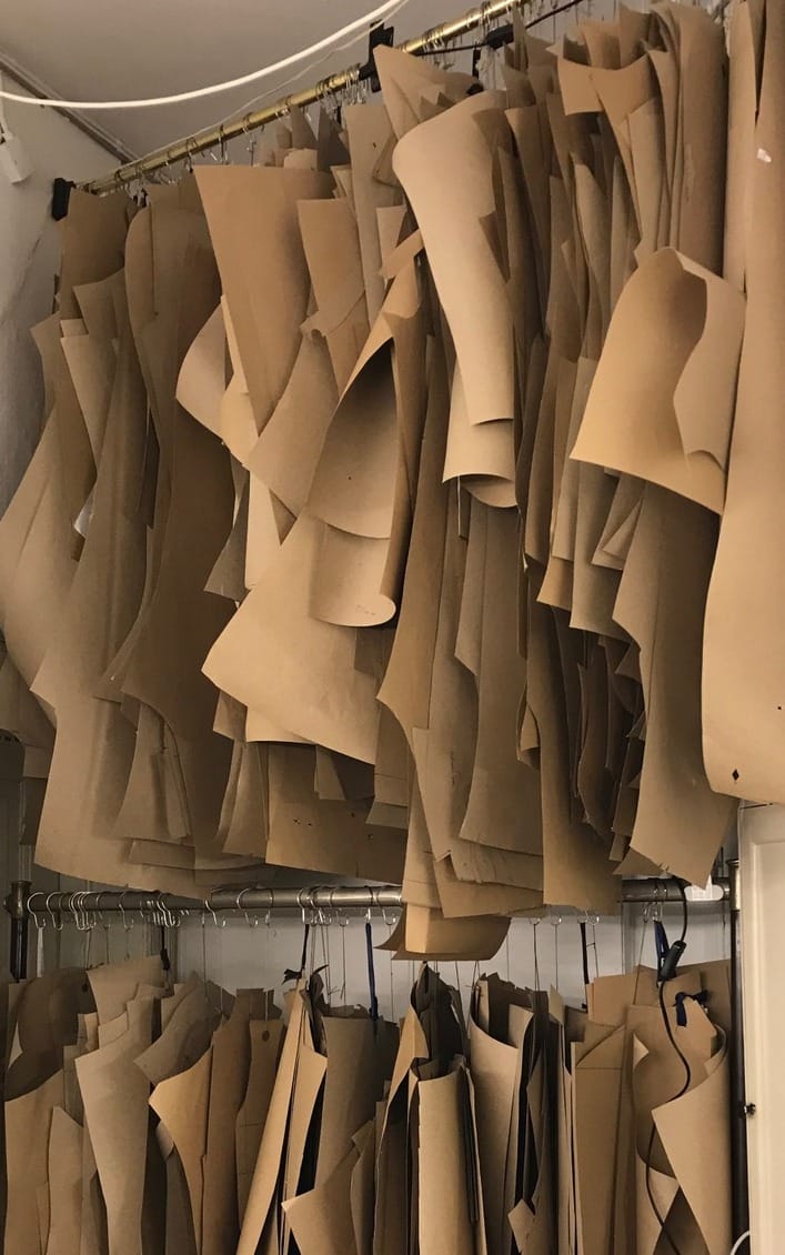 Customers' paper patterns hanging in the workshop
