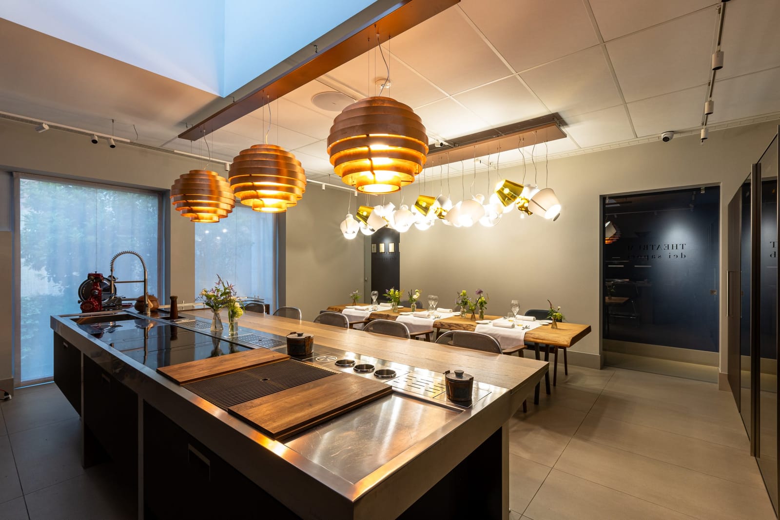The cooking island and the tables laid for dinner