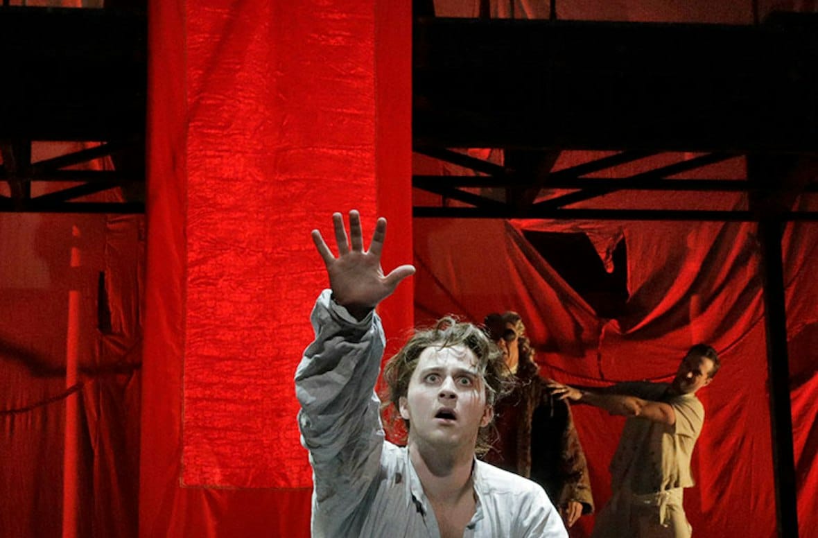The Inquisition scene, under red banners