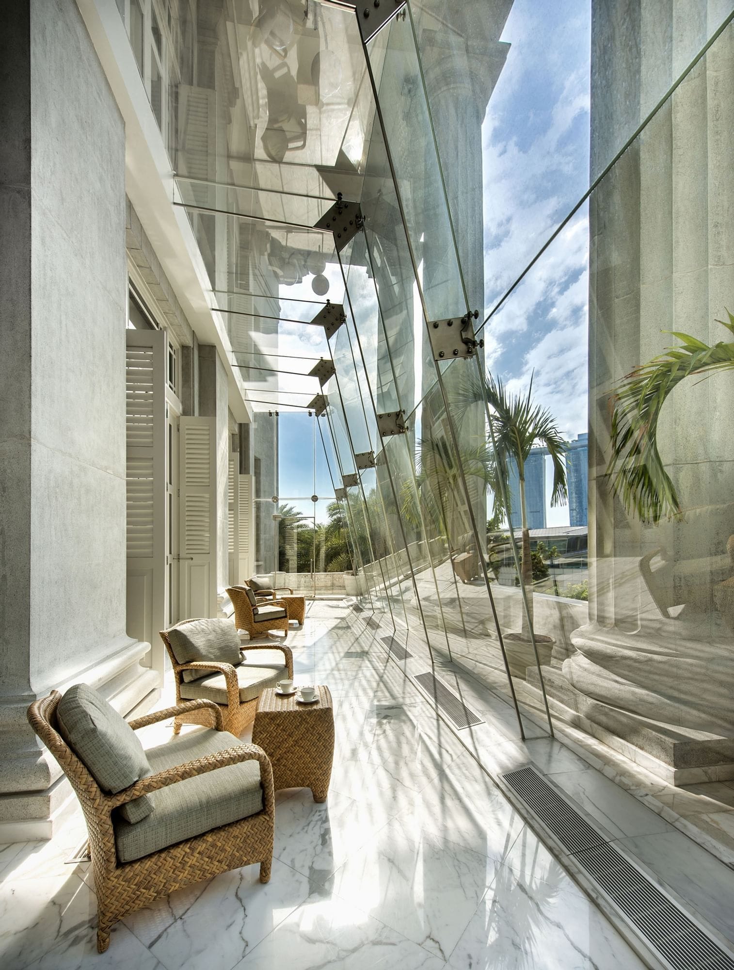 The glass-enclosed verandah behind the Doric columns