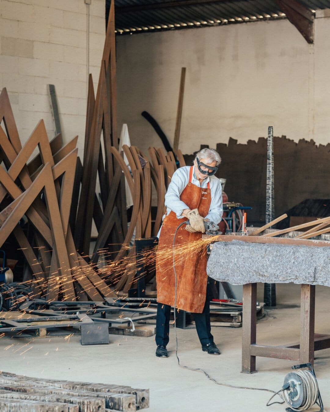 Venet cutting steel among his Arcs and Angles in the studio
