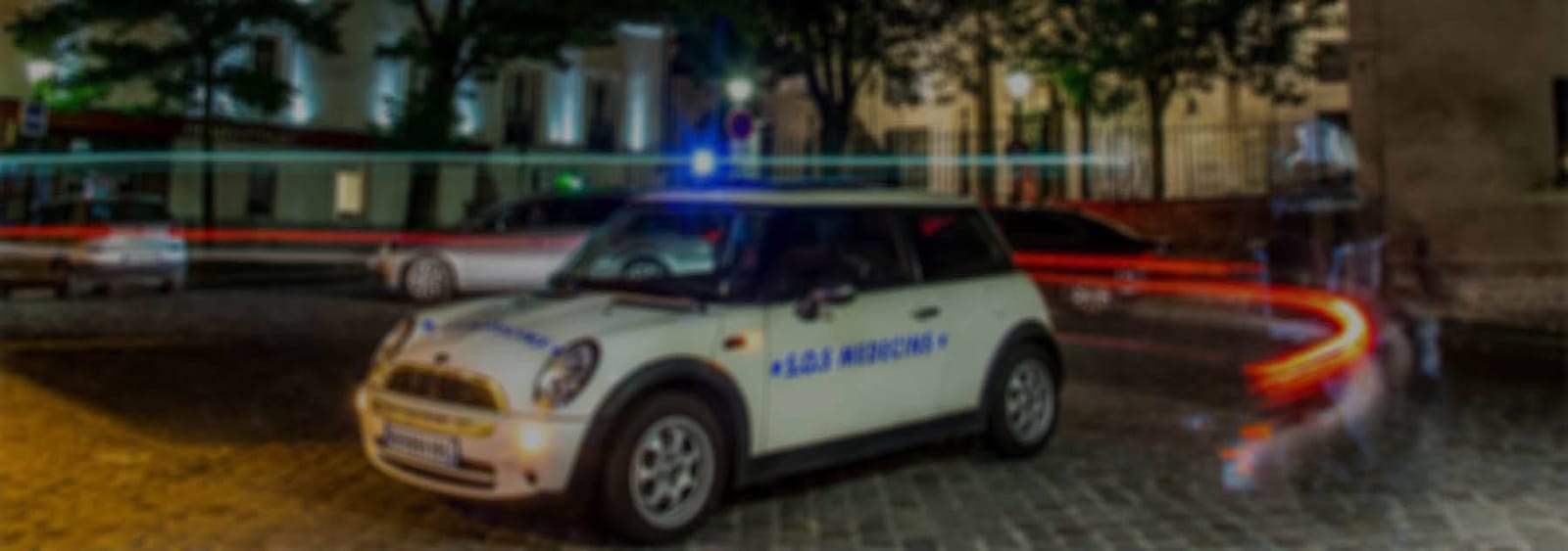 An SOS Médecins car on a Paris street at night