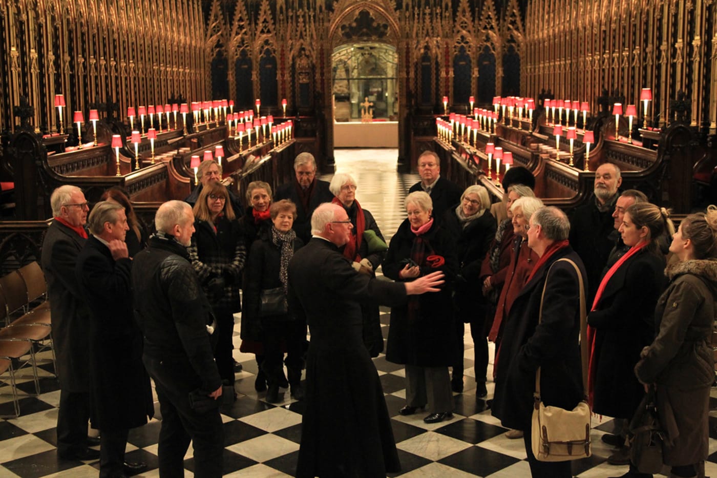 A verger with a tour group in the quire