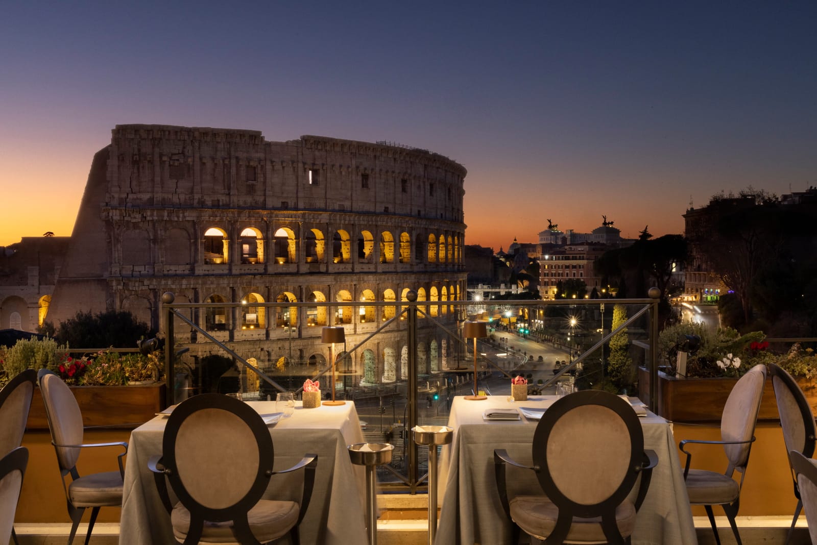 Terrace tables facing the Colosseum at dusk