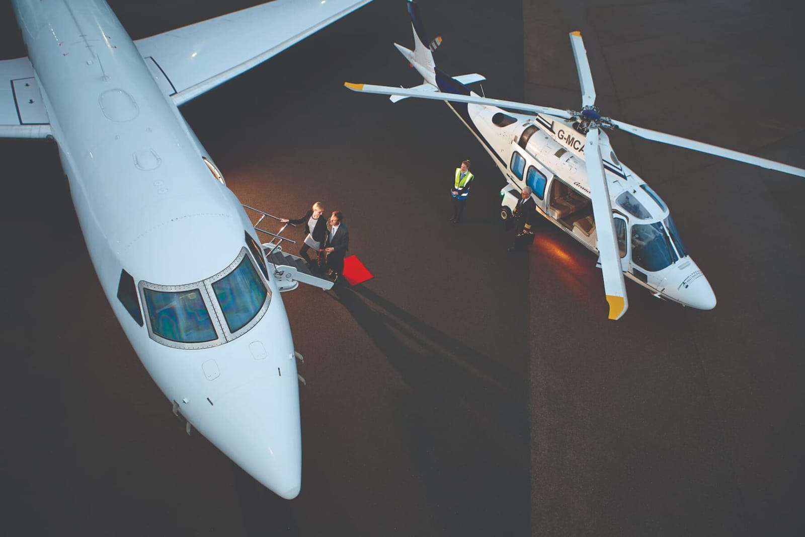 Jet and shuttle helicopter side by side on the ramp