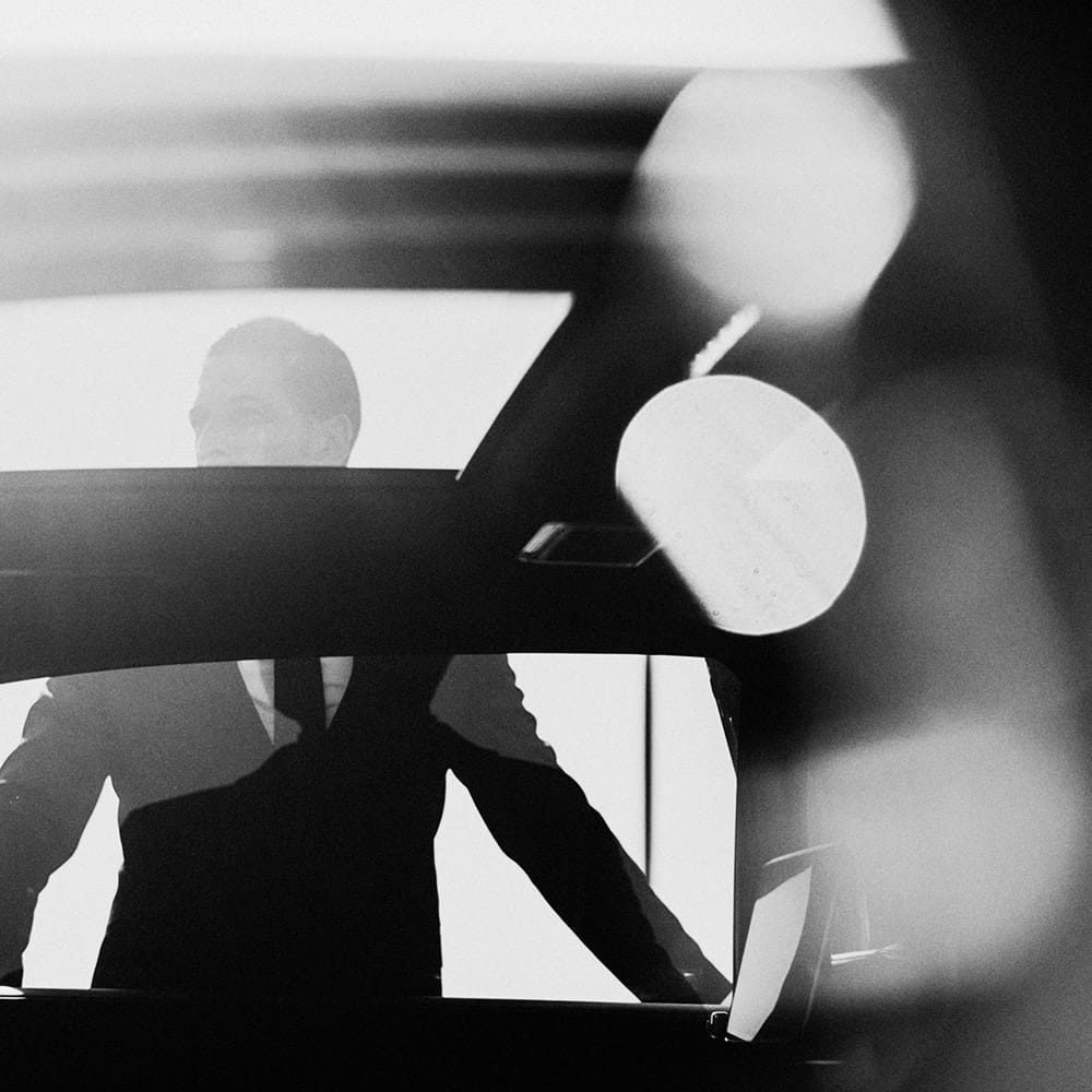 A chauffeur holding the car door open