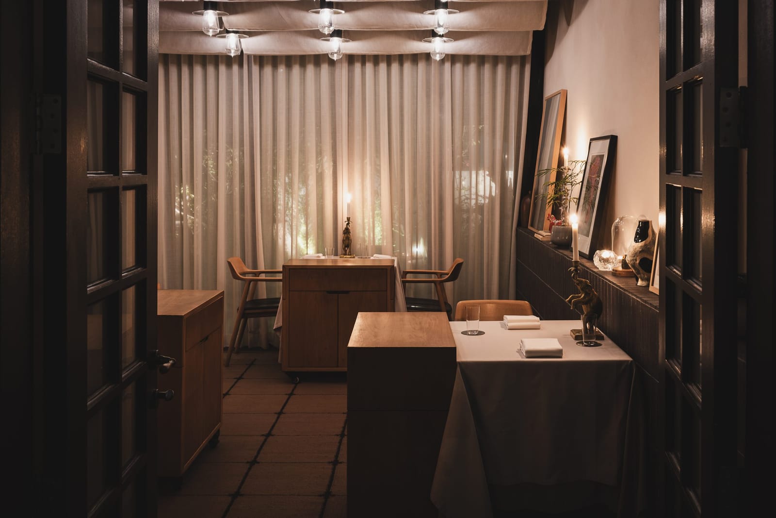 A small dining room behind glazed doors