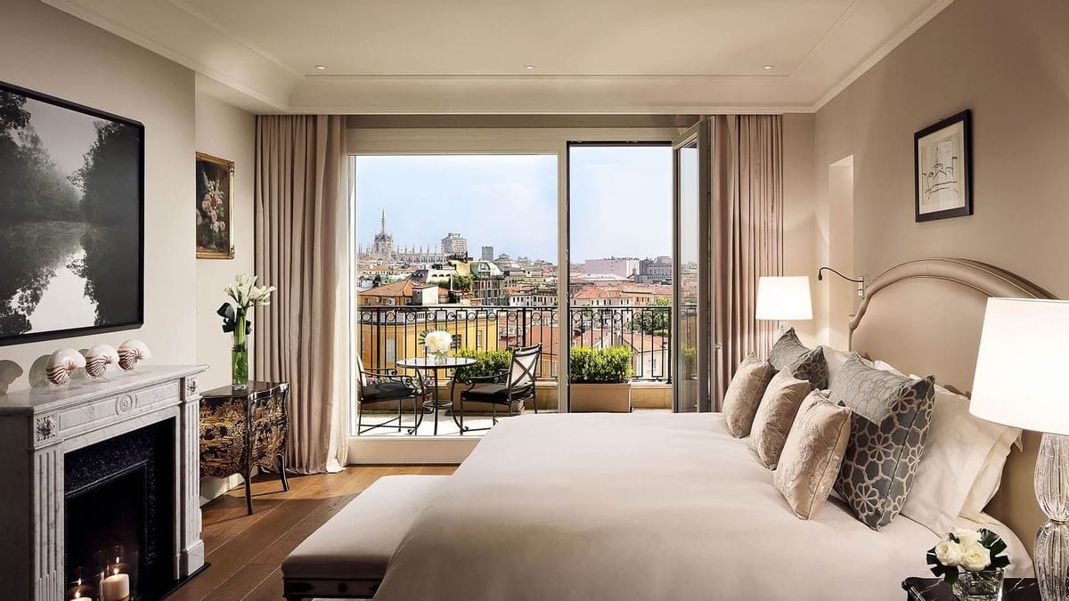 The bedroom, with a fireplace and a balcony