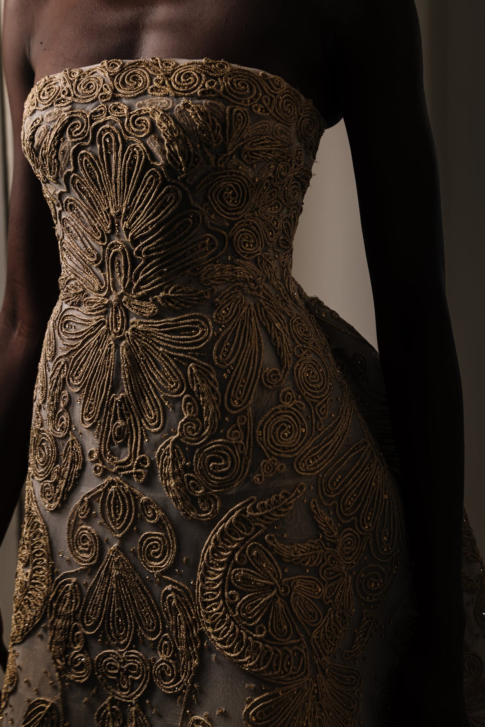 Corded gold embroidery on a strapless bodice