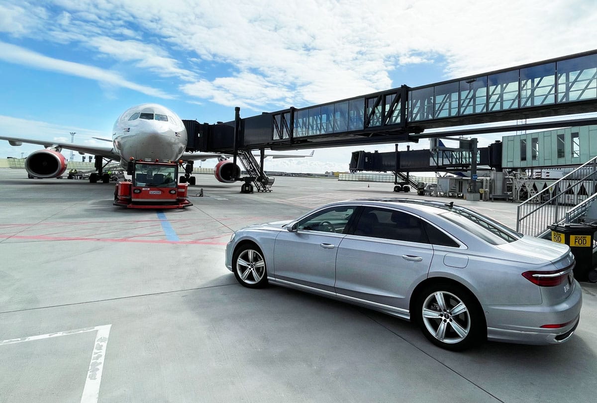 The car on the apron beside the aircraft