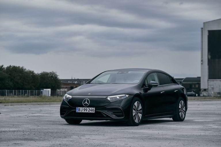 The Mercedes EQS by a hangar