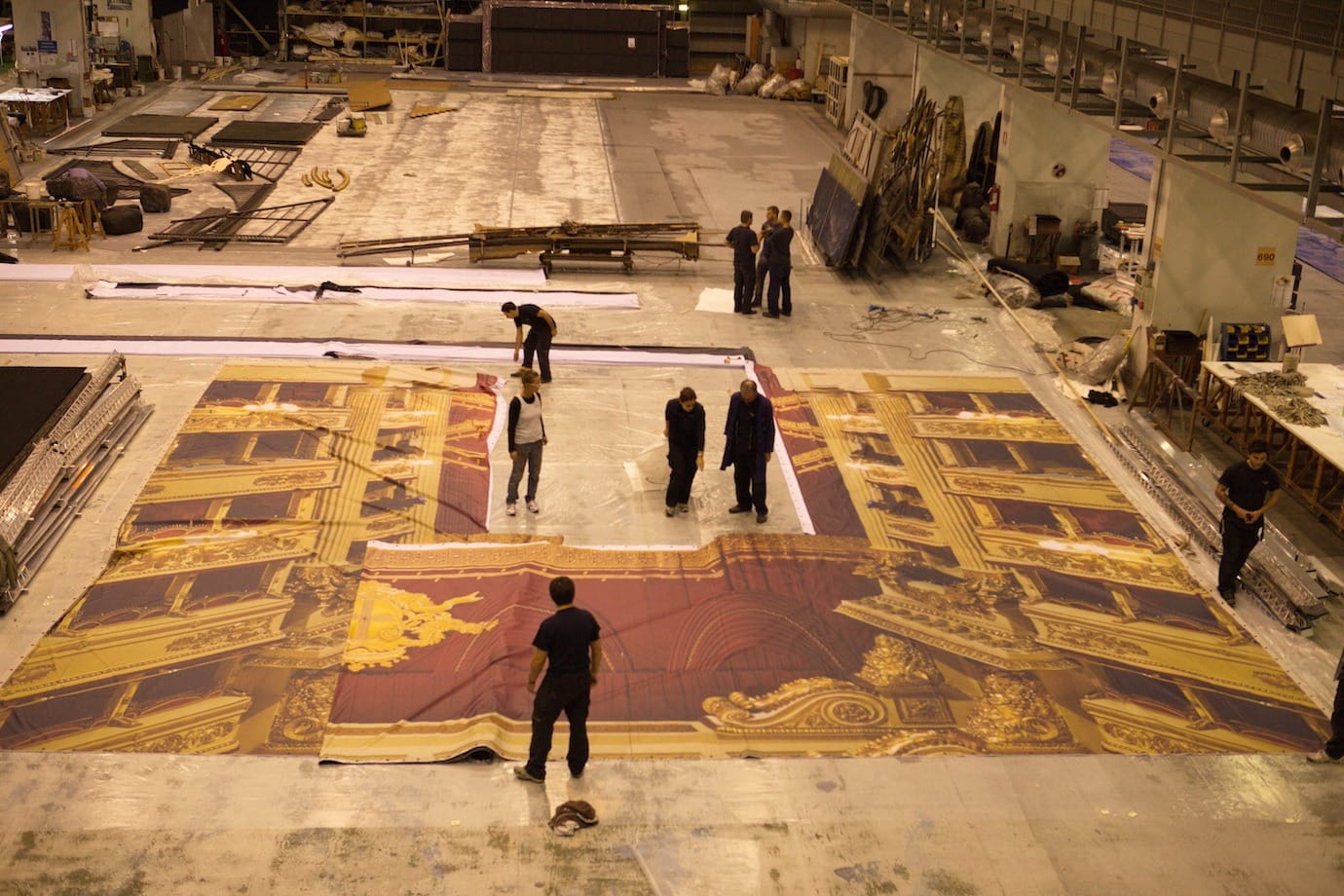 A painted backdrop laid out on the workshop floor