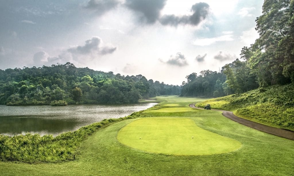 The sixteenth tee beside a lake in the forest